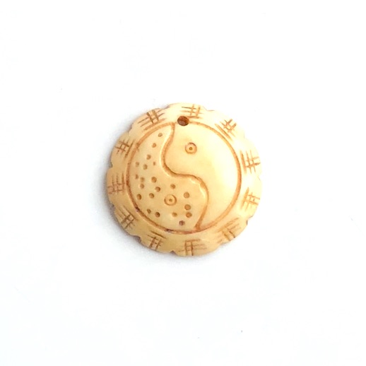 A Pendant, antiqued bone, 32mm carved yin yang. each