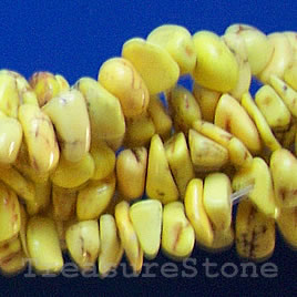 Bead, dyed turquoise, yellow, chip. 15.5-inch strand.