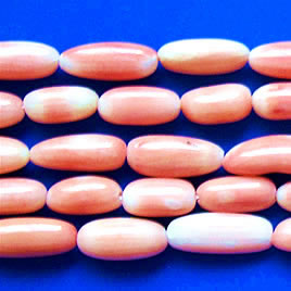 Bead, coral (dyed), peach, 11-14mm oval. 16-inch strand.