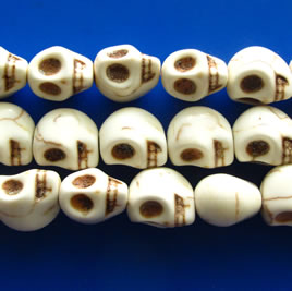 Bead, white turquoise, center-drilled, 10x12mm skull. 16 inch.