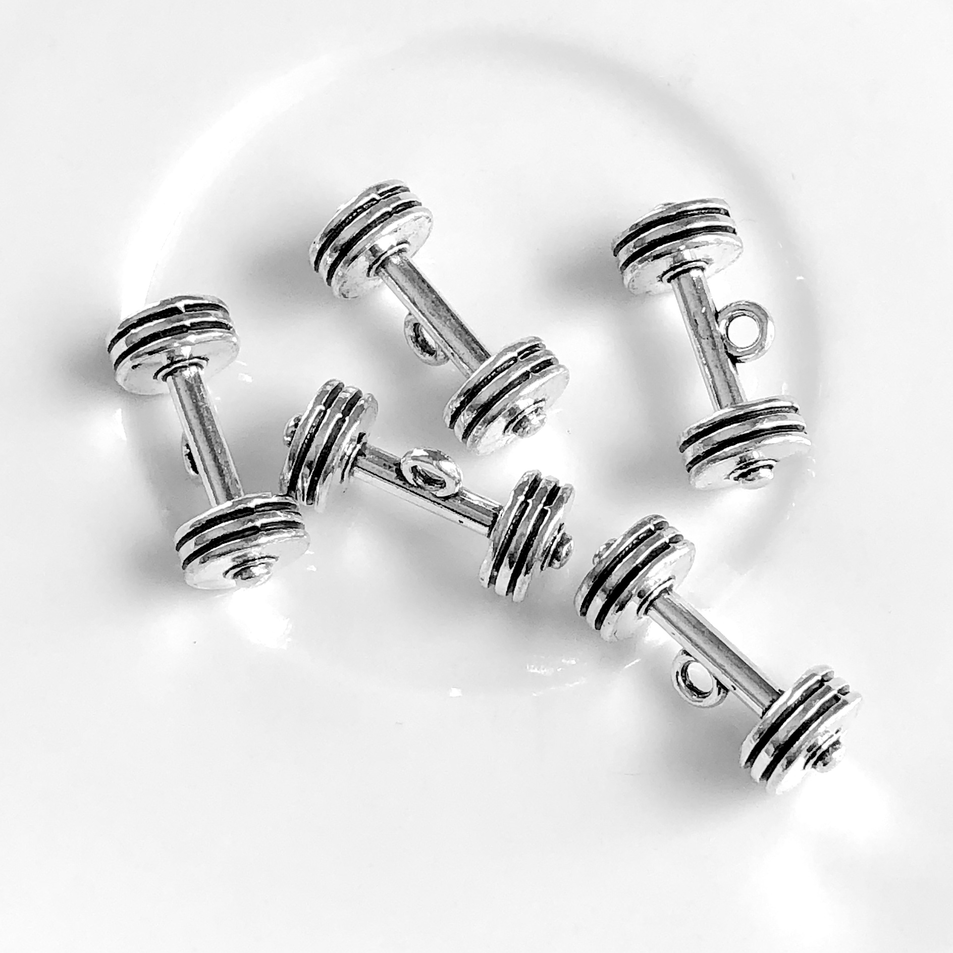 Charm, pendant, silver-finished, 9x22mm dumbbell, 3D. Pkg of 4